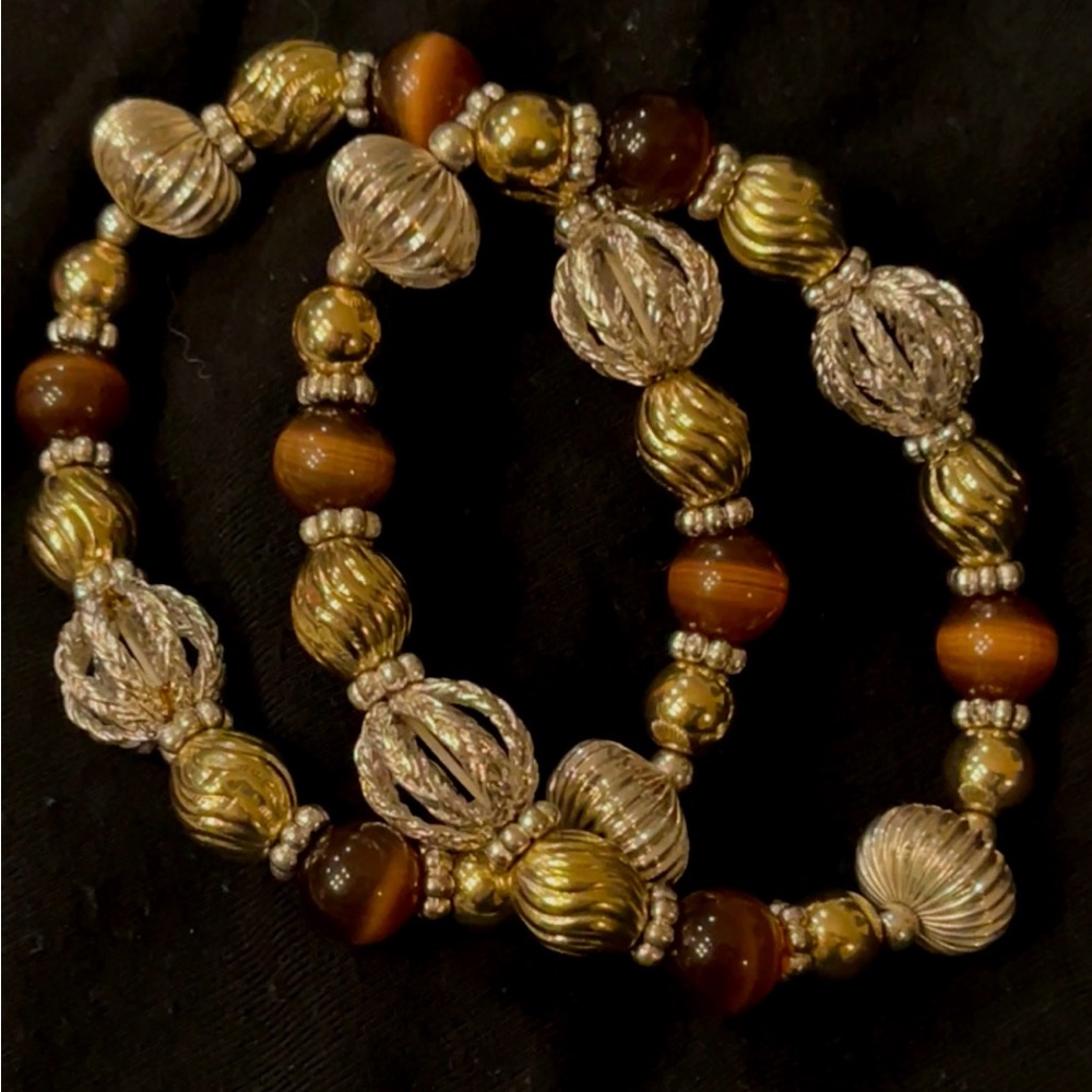 A set of 2  gold tone & silver tone stretch bracelets w/ tiger eye like beads